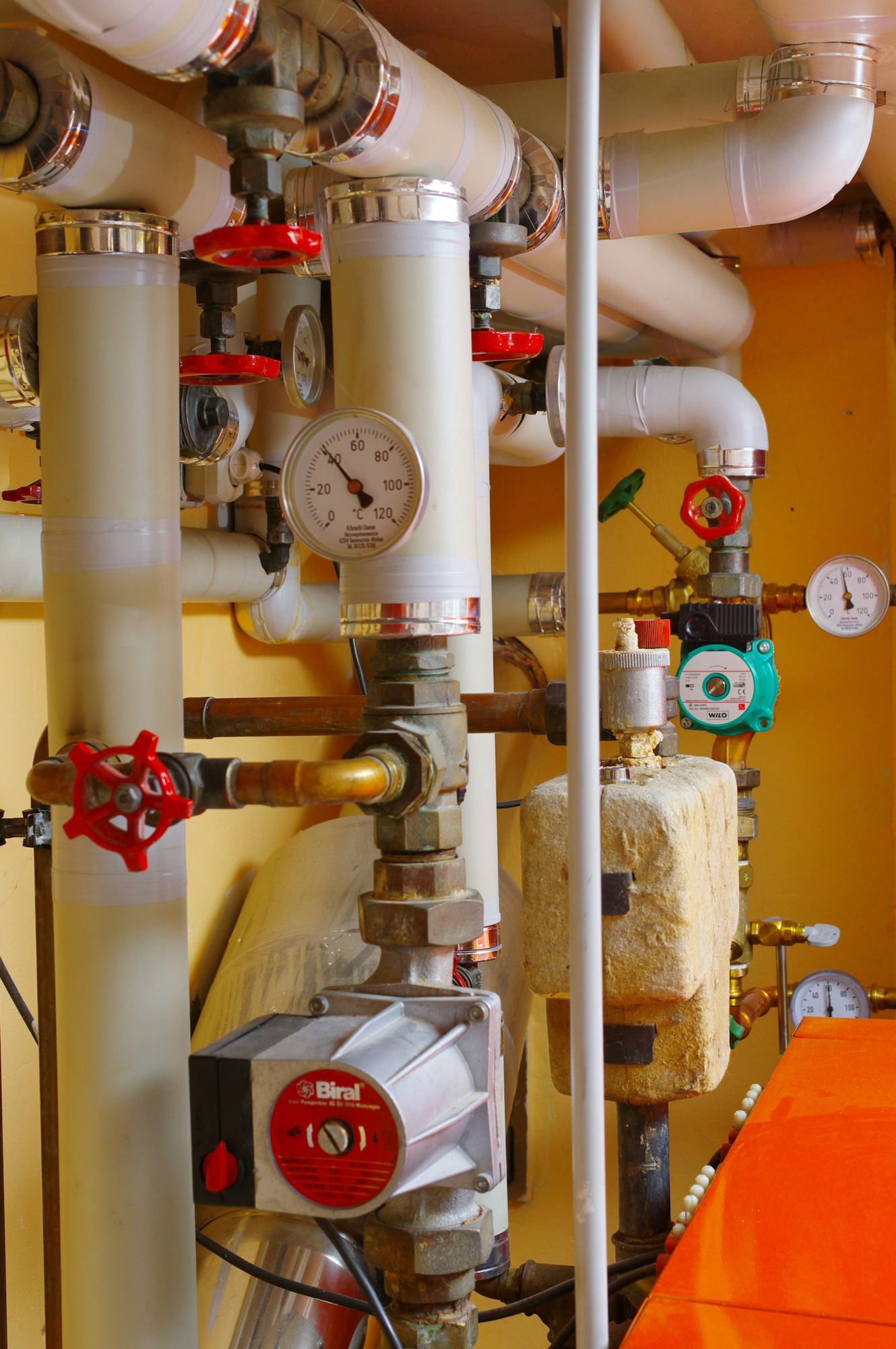 Pipes, valves and pressure gauges in a heating plant room
